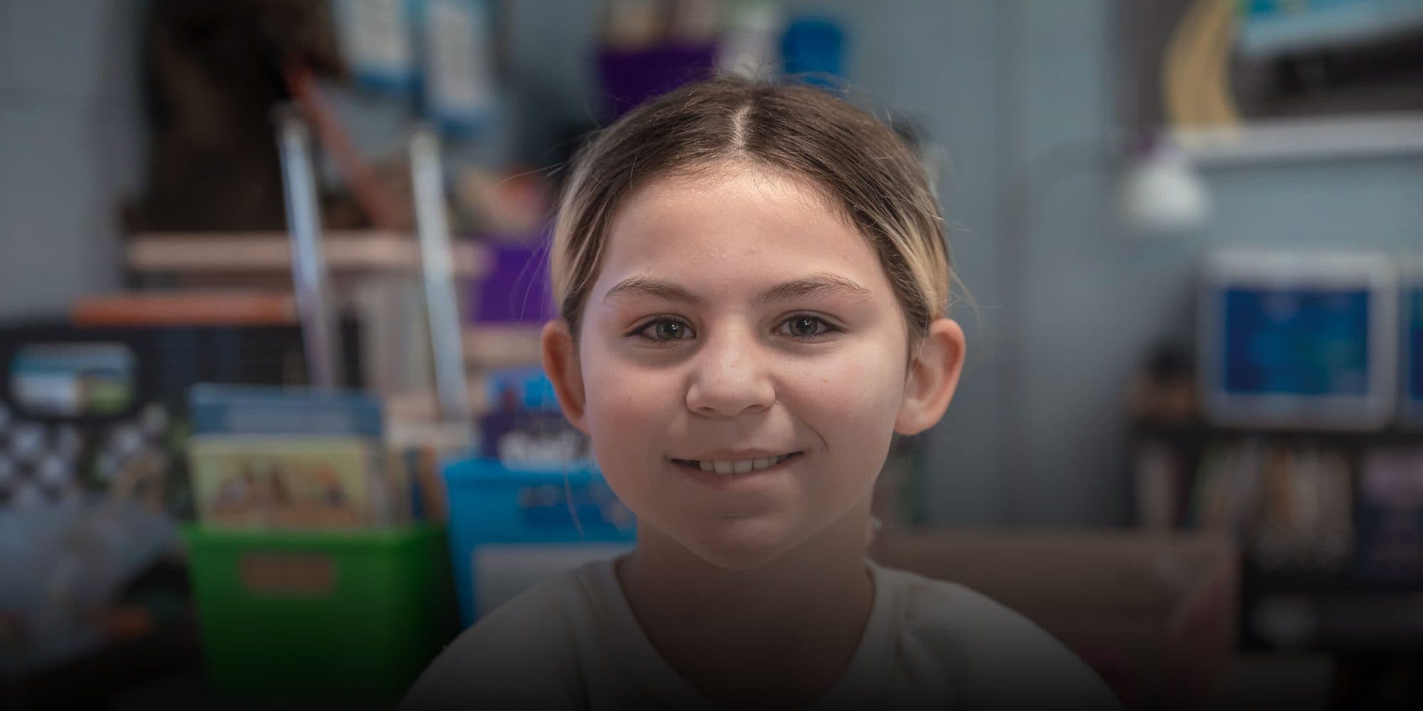 Smiling student in a classroom.