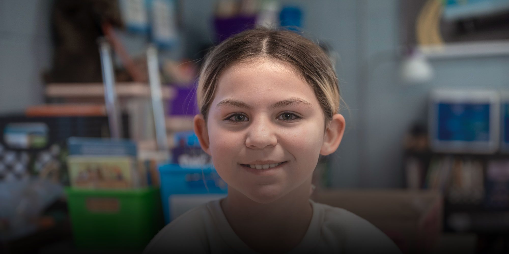 Smiling student in a classroom.